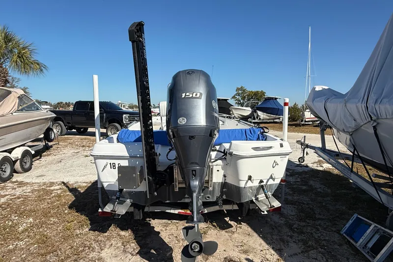 Slide: The Image of 2002 Cobia 191 Bay boat with Yamaha 150 engine in outdoor storage. - 5