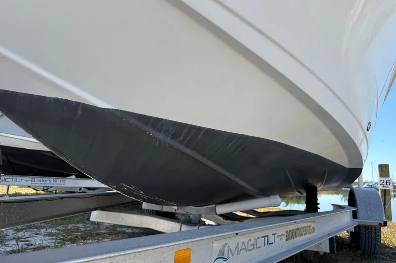 Slide: The Image of 2002 Cobia 191 Bay boat on Magic Tilt trailer, close-up view of hull. - 8