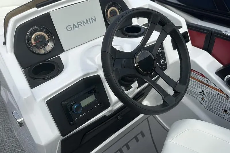 Slide: The Image of Steering console of 2026 Evotti 521CS boat with Garmin display and controls. - 16