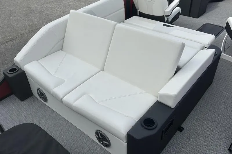 Slide: The Image of White seating area on 2026 Evotti 521CS boat, featuring cup holders and speakers. - 23