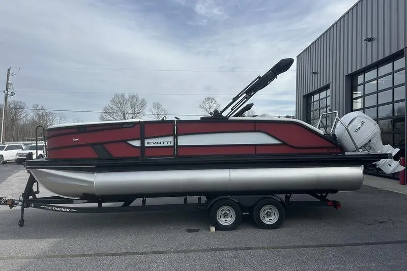 Slide: The Image of 2026 Evotti 521CS pontoon boat on trailer, parked outside a building. - 5