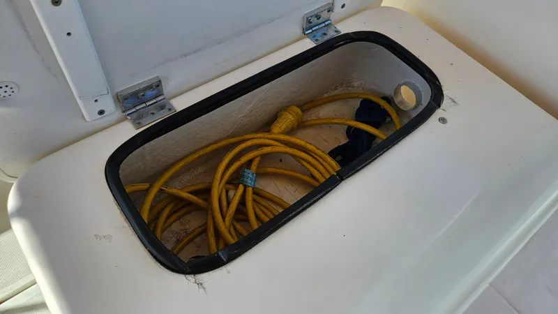 Slide: The Image of Storage compartment with yellow cable on 2006 Tiara Yachts 2900 Coronet. - 10