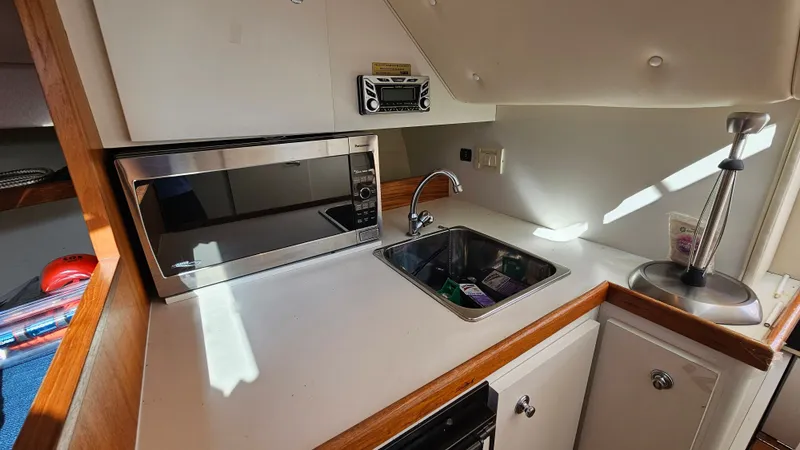 Slide: The Image of Tiara Yachts 2900 Coronet 2006 kitchen area with microwave and sink. - 17