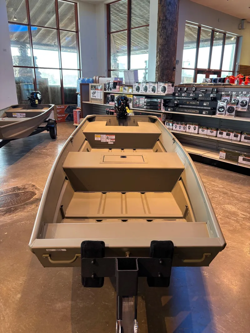 Slide: The Image of 2025 Tracker Grizzly 1542 Utility boat displayed in a showroom. - 12