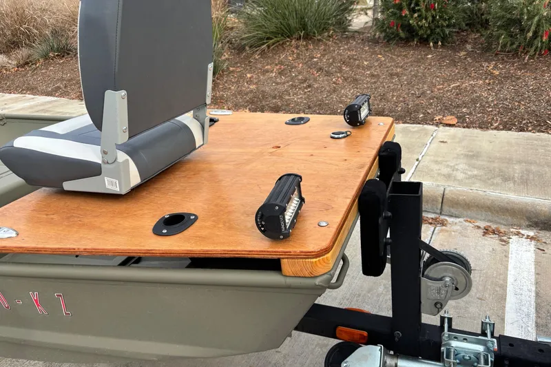 Slide: The Image of 2025 Tracker Grizzly 1542 Utility boat with mounted seat and LED lights on trailer. - 3