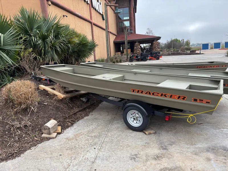 Slide: The Image of 2025 Tracker Grizzly 1542 Utility boat on trailer, parked outdoors. - 30