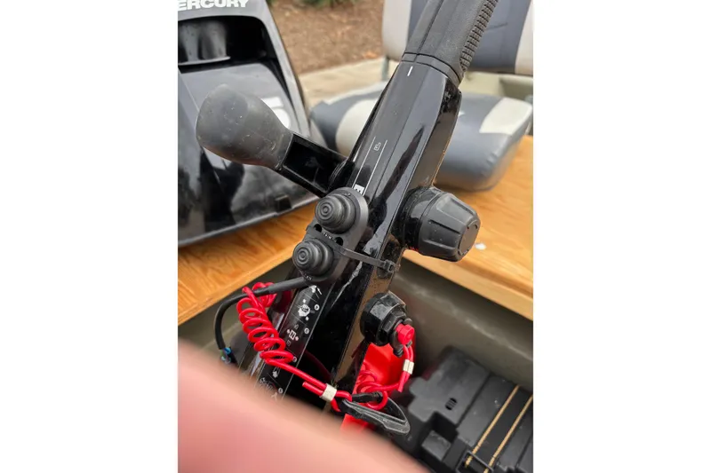 Slide: The Image of 2025 Tracker Grizzly 1542 Utility boat control panel with Mercury engine handle. - 4