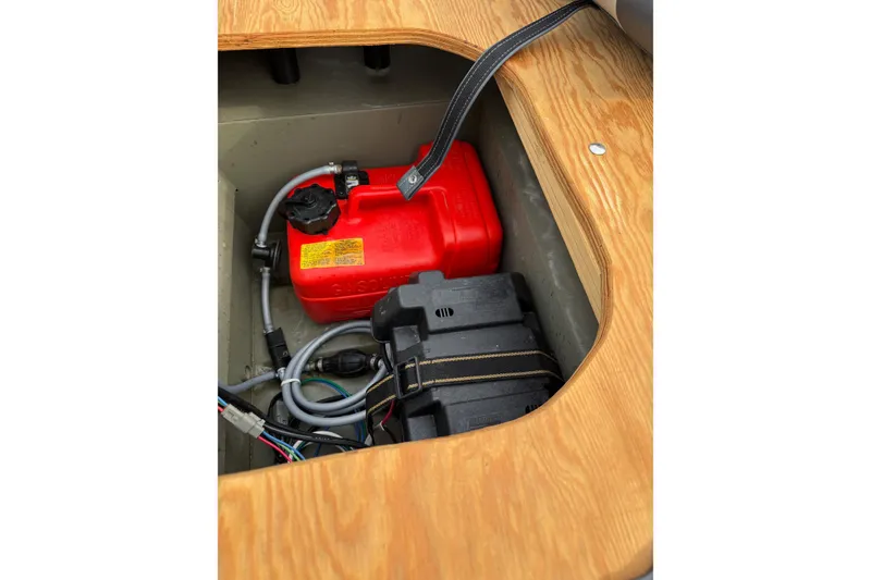 Slide: The Image of 2025 Tracker Grizzly 1542 Utility boat interior with red fuel tank and battery compartment. - 6