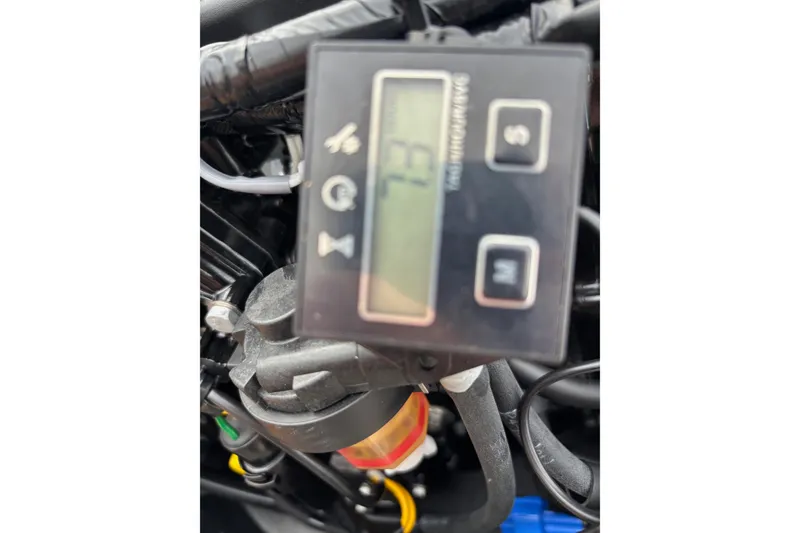 Slide: The Image of Close-up of Tracker Grizzly 1542 Utility 2025 engine component with digital display. - 7