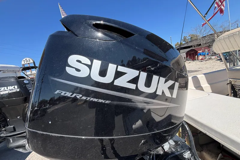Slide: The Image of Suzuki four-stroke engine on 2016 Carolina Skiff 16 JVX CC boat, sunny day. - 10