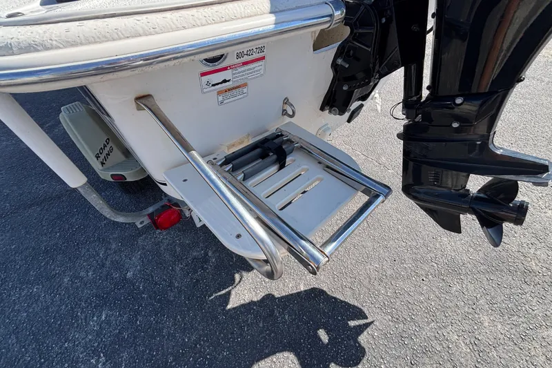 Slide: The Image of 2016 Carolina Skiff 16 JVX CC boat with motor and ladder on trailer. - 12