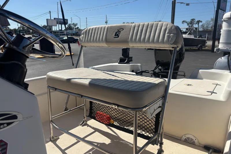 Slide: The Image of 2016 Carolina Skiff 16 JVX CC boat interior with steering wheel and cushioned seating. - 16