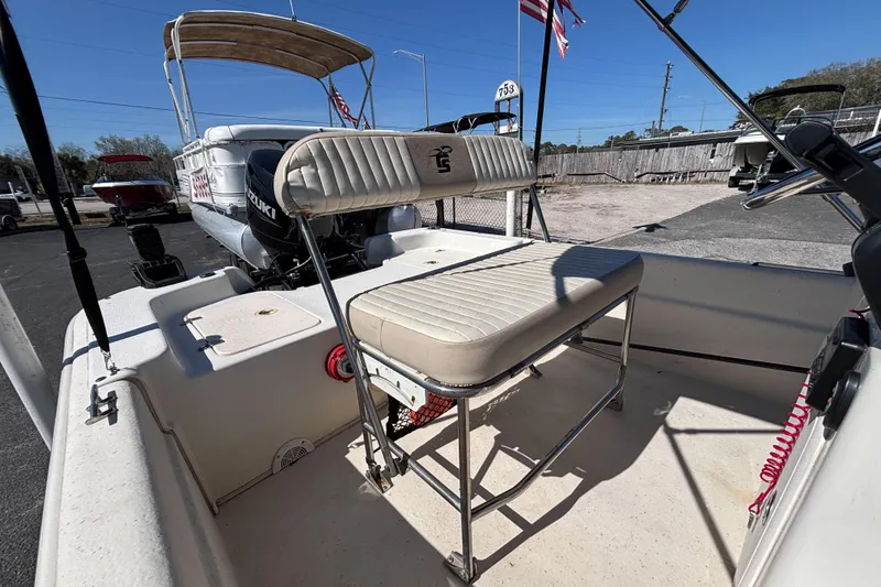 Slide: The Image of 2016 Carolina Skiff 16 JVX CC boat interior with seating and Suzuki outboard motor. - 19