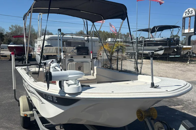 Slide: The Image of 2016 Carolina Skiff 16 JVX CC boat with canopy on trailer in outdoor setting. - 2