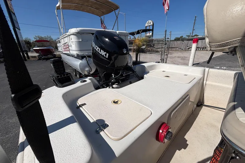 Slide: The Image of 2016 Carolina Skiff 16 JVX CC with Suzuki outboard motor, parked outdoors. - 20