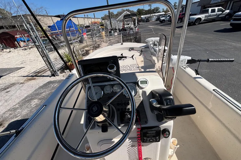 Slide: The Image of 2016 Carolina Skiff 16 JVX CC boat dashboard with steering wheel and controls. - 22