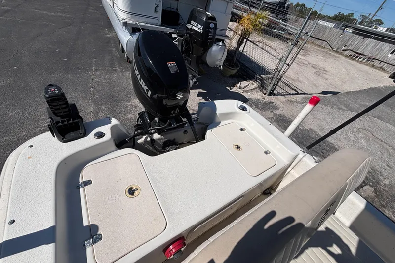 Slide: The Image of 2016 Carolina Skiff 16 JVX CC boat with Suzuki outboard motor, parked on pavement. - 23