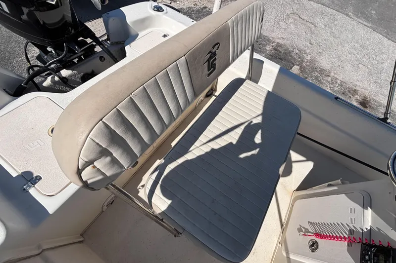 Slide: The Image of 2016 Carolina Skiff 16 JVX CC boat interior with cushioned seating and control panel. - 24