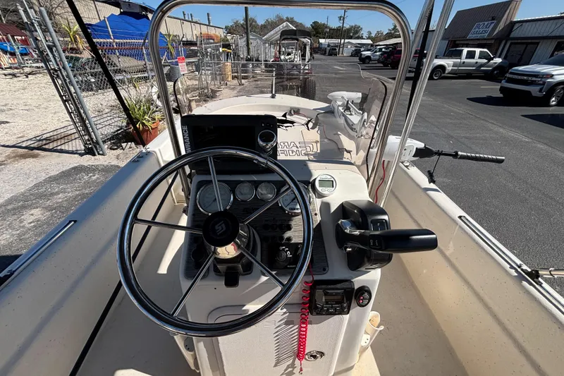 Slide: The Image of 2016 Carolina Skiff 16 JVX CC boat interior with steering wheel and controls. - 25