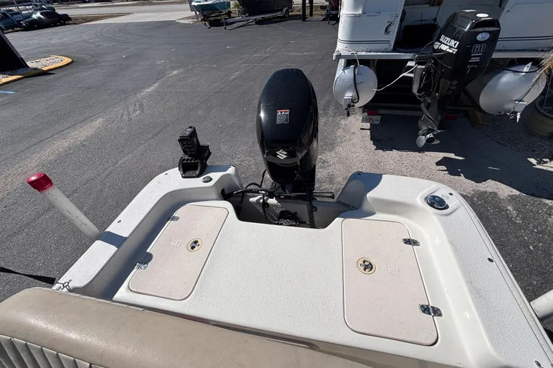 Slide: The Image of 2016 Carolina Skiff 16 JVX CC boat with Suzuki outboard motor, docked on pavement. - 33