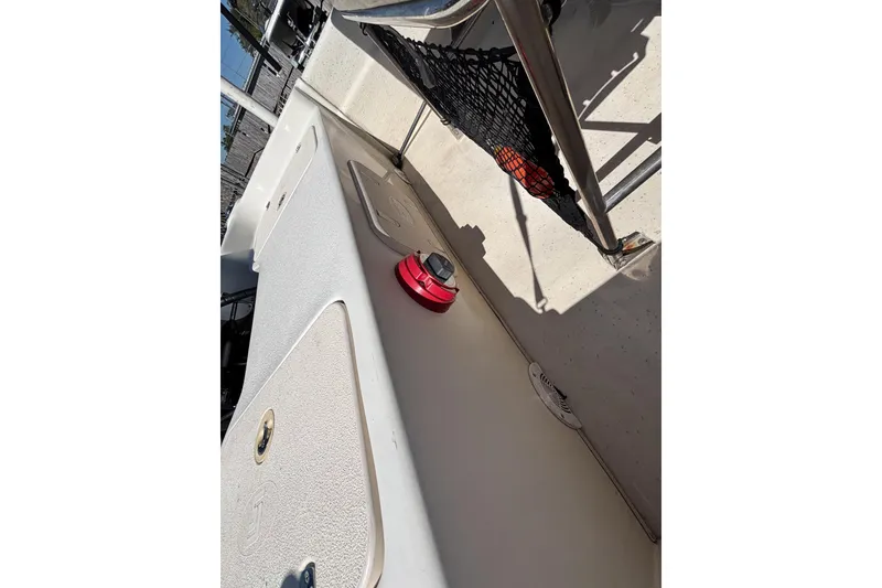 Slide: The Image of 2016 Carolina Skiff 16 JVX CC boat interior with storage compartments and safety equipment. - 34