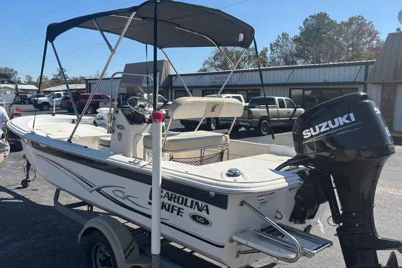 Slide: The Image of 2016 Carolina Skiff 16 JVX CC boat with Suzuki outboard motor in parking lot. - 6