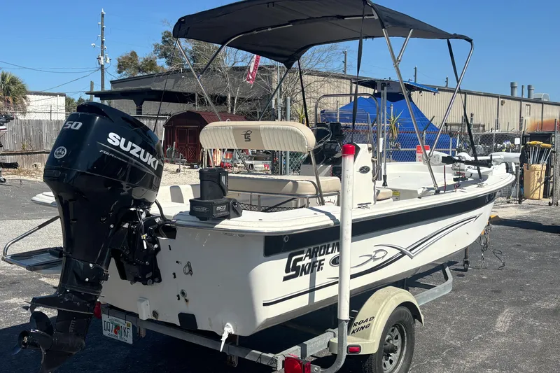 Slide: The Image of 2016 Carolina Skiff 16 JVX CC boat with Suzuki outboard motor on trailer. - 9