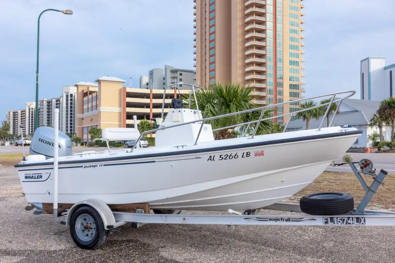 The Image of 1999 Boston Whaler Outrage 17 boat on trailer, cityscape background. - 0