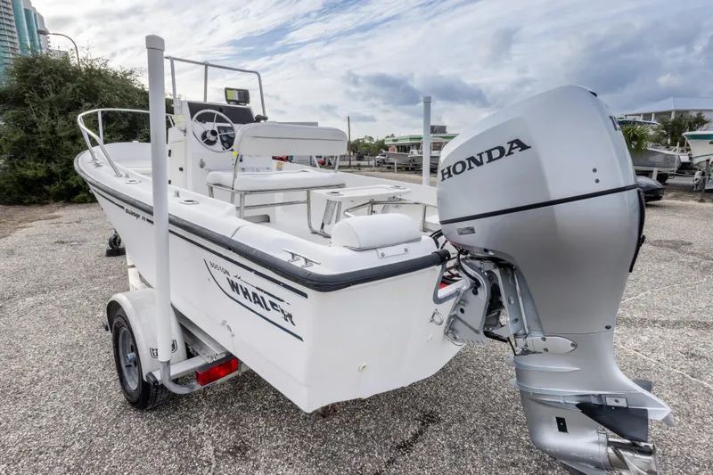 Slide: The Image of 1999 Boston Whaler Outrage 17 boat with Honda outboard motor on a trailer. - 11