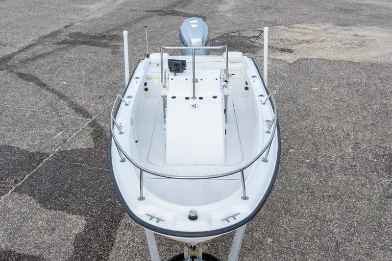 Slide: The Image of 1999 Boston Whaler Outrage 17 boat on pavement, top view. - 12