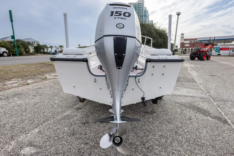 Slide: The Image of 1999 Boston Whaler Outrage 17 with Honda 150 VTEC outboard motor, parked on pavement. - 15