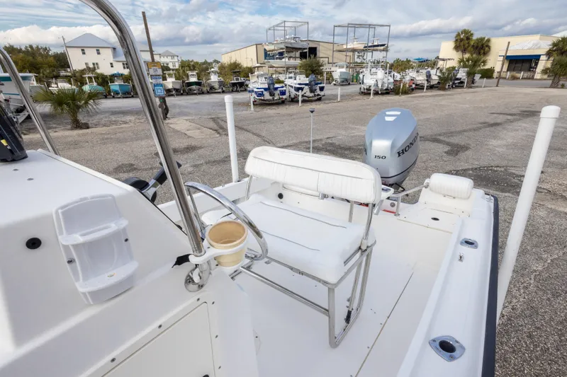 Slide: The Image of 1999 Boston Whaler Outrage 17 boat with Honda engine in a marina setting. - 20