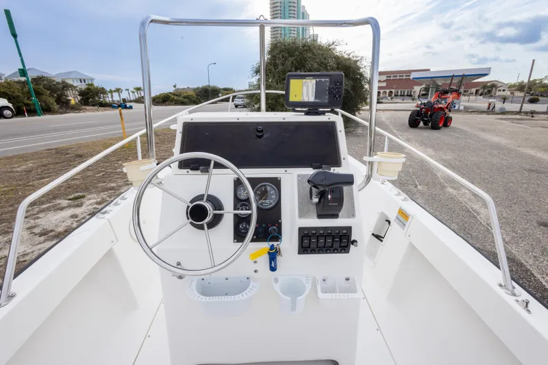 Slide: The Image of 1999 Boston Whaler Outrage 17 boat console with steering wheel and navigation equipment. - 21