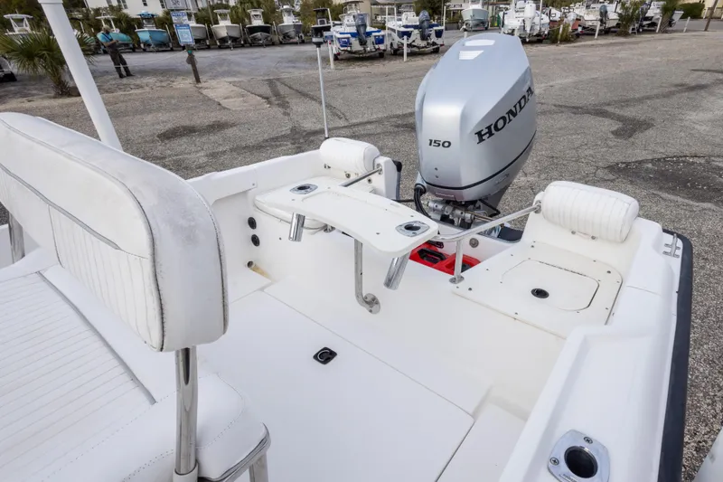 Slide: The Image of 1999 Boston Whaler Outrage 17 with Honda 150 outboard motor, docked in a marina. - 23