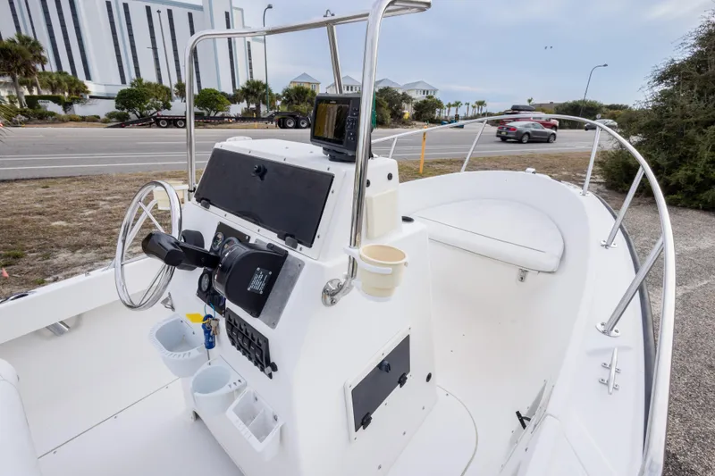 Slide: The Image of 1999 Boston Whaler Outrage 17 boat interior with steering console and seating. - 26