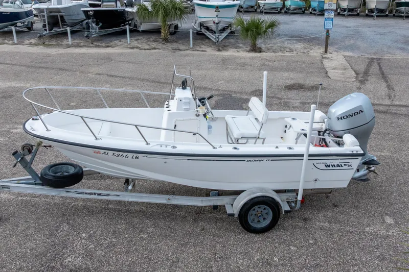Slide: The Image of 1999 Boston Whaler Outrage 17 boat on trailer with Honda outboard motor. - 3