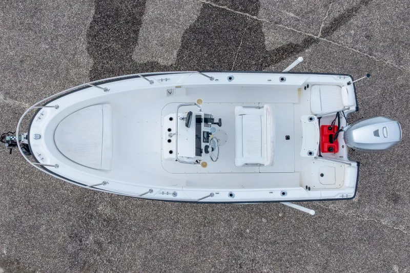 Slide: The Image of Overhead view of a 1999 Boston Whaler Outrage 17 boat on pavement. - 5