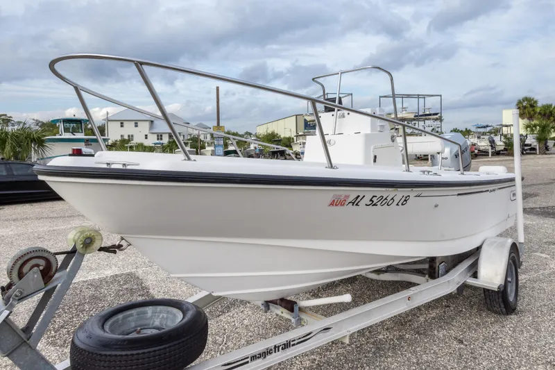 Slide: The Image of 1999 Boston Whaler Outrage 17 boat on trailer in a marina setting. - 8