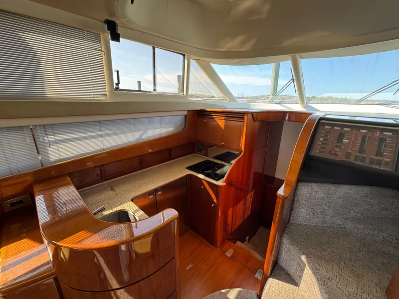 Slide: The Image of Interior of 2005 Viking Princess 50 Flybridge yacht with wood finish and modern kitchen area. - 14