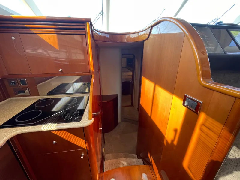 Slide: The Image of Interior of 2005 Viking Princess 50 Flybridge yacht with wooden cabinetry and modern kitchen. - 16