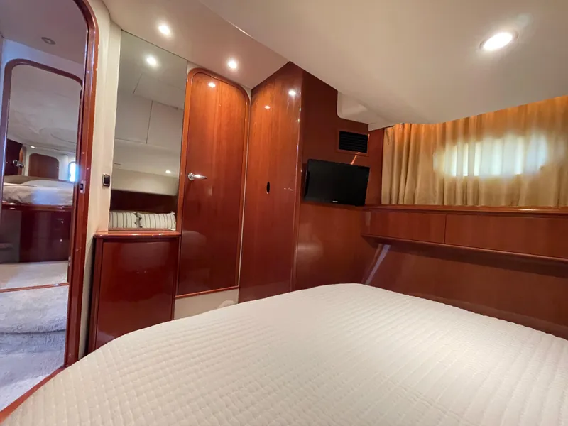 Slide: The Image of Luxurious cabin interior of 2005 Viking Princess 50 Flybridge yacht with wood finish and cozy bedding. - 21