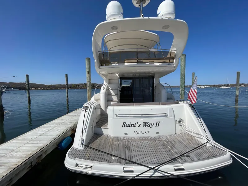 Slide: The Image of 2005 Viking Princess 50 Flybridge yacht docked, rear view with American flag. - 3