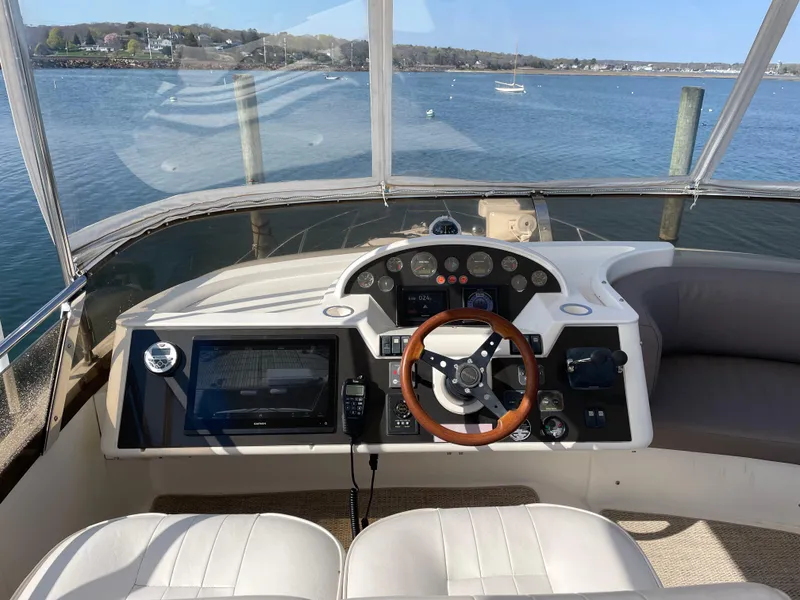 Slide: The Image of Flybridge helm of 2005 Viking Princess 50, featuring steering wheel and navigation controls. - 30