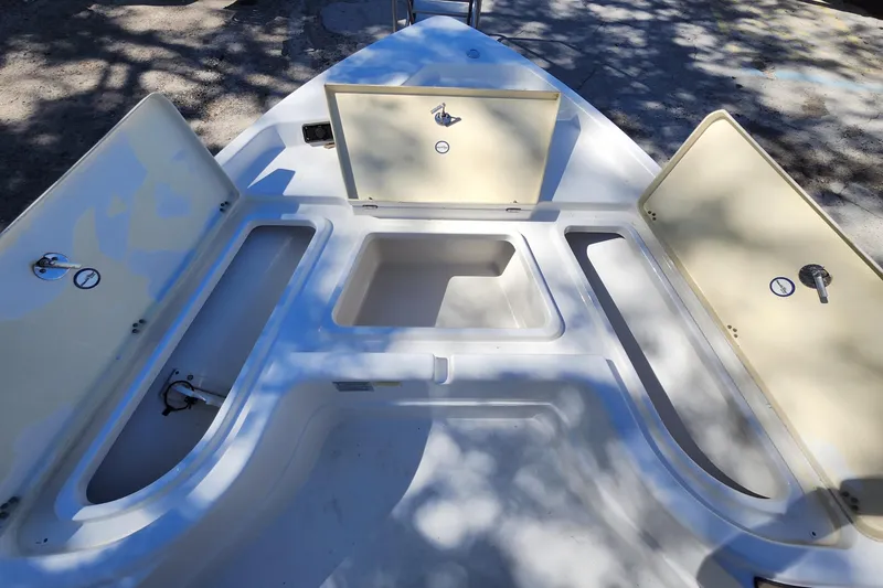 Slide: The Image of 2020 NauticStar 195 NauticBay boat storage compartments open under sunlight. - 11
