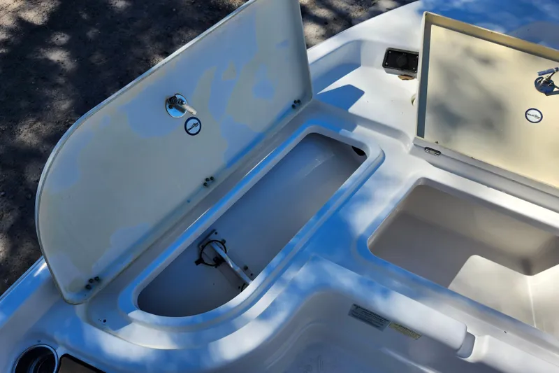 Slide: The Image of Open storage compartments on a 2020 NauticStar 195 NauticBay boat deck. - 12