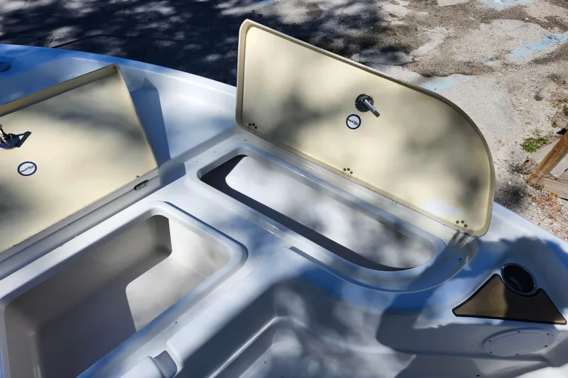 Slide: The Image of 2020 NauticStar 195 NauticBay boat storage compartments open, showing interior details. - 13