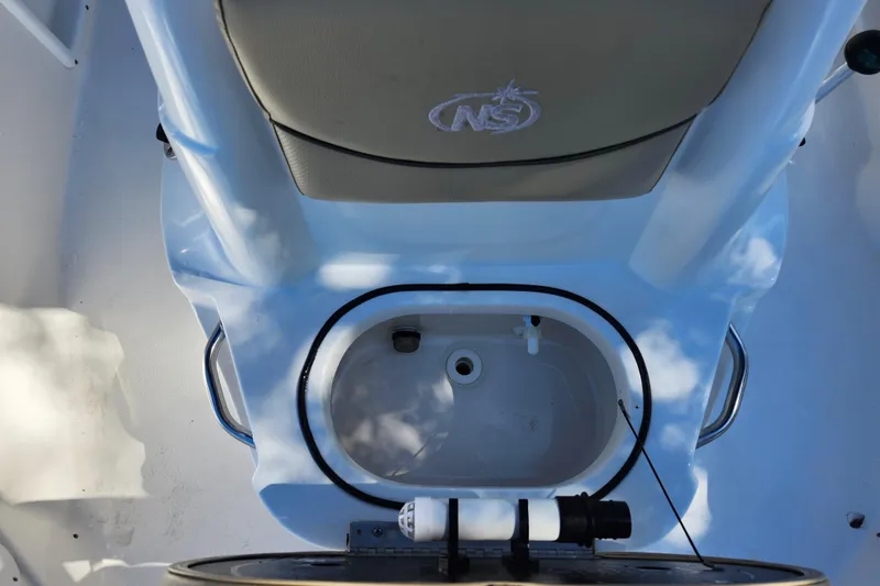 Slide: The Image of 2020 NauticStar 195 NauticBay boat interior with seating and storage compartment. - 15