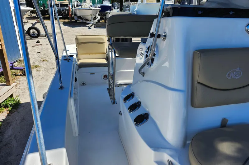 Slide: The Image of 2020 NauticStar 195 NauticBay boat interior with seating and control panel. - 16