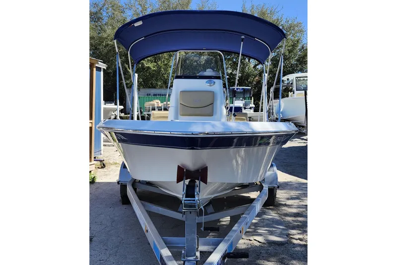 Slide: The Image of 2020 NauticStar 195 NauticBay boat on trailer with blue canopy. - 2