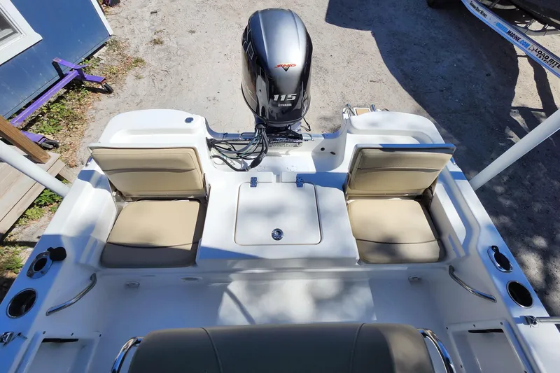 Slide: The Image of 2020 NauticStar 195 NauticBay boat with Yamaha 115 engine, beige seating, and white deck. - 24